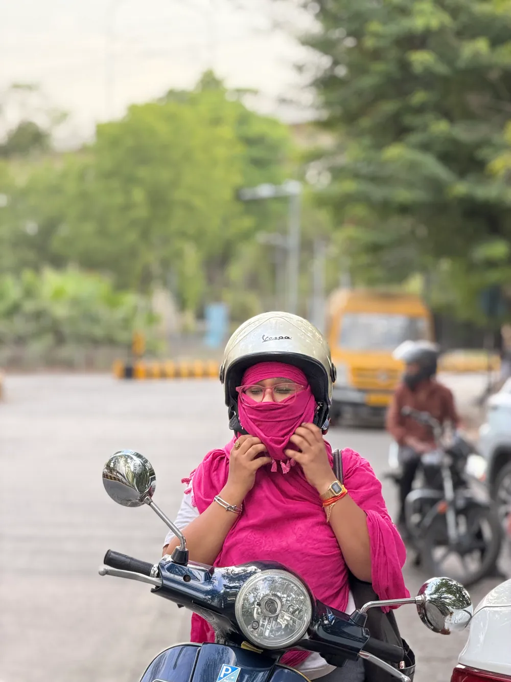 Traditional dupatta wrapped over the face — borrowed protection that slips and needs constant adjustment